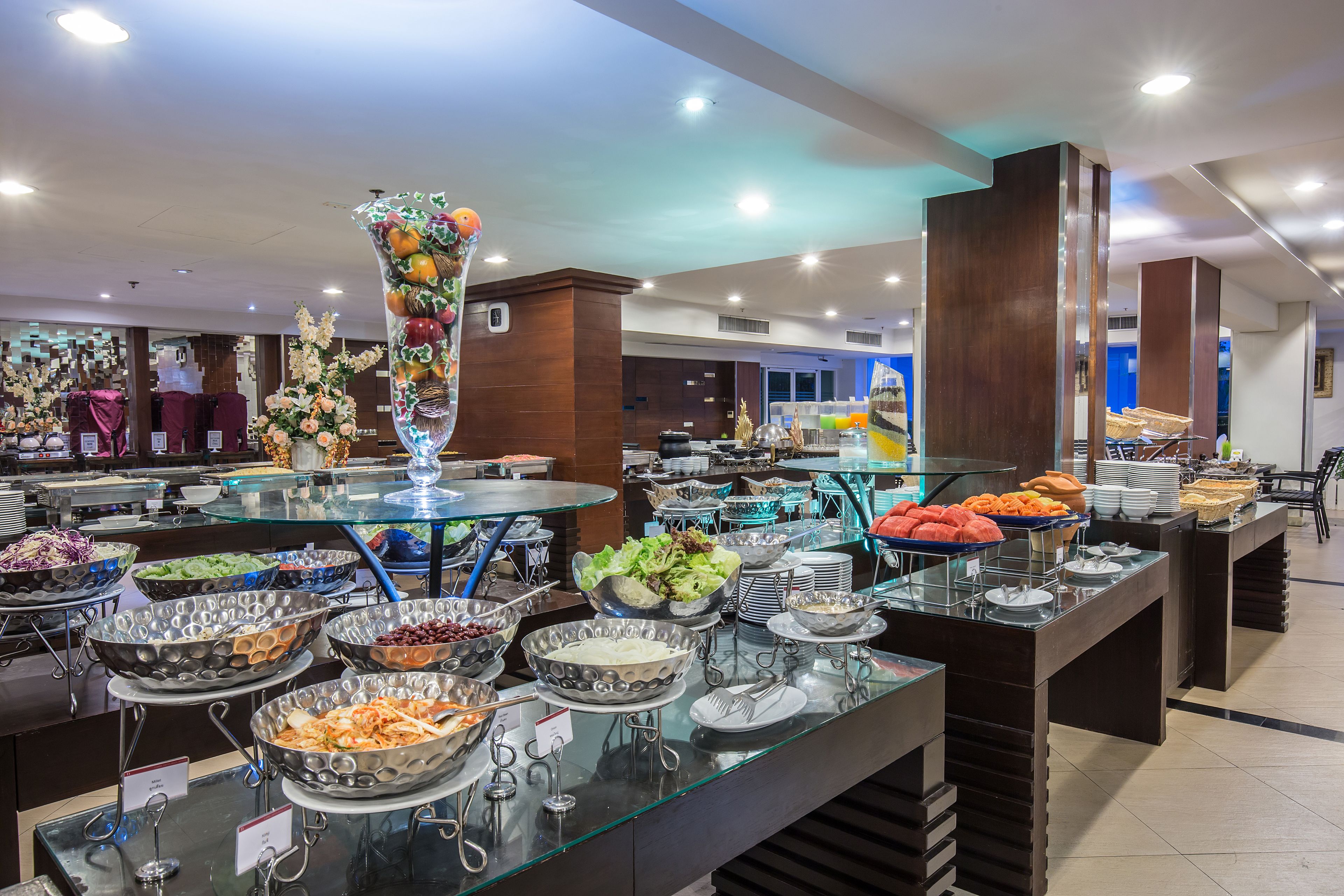A buffet area with various food items and a decorative vase.