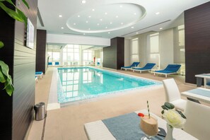 Indoor pool, open 10:00 AM to 10:00 PM, pool loungers