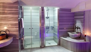 A modern bathroom with a glass-enclosed shower, a marble sink, and a vanity with a mirror. - Kitapevi Special Class Hotel (Bursa)