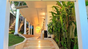 A spa entrance with a sign reading 'Enjoy The Spa,' a staircase leading inside, and potted plants around. - Lavender Villa and Spa (Kuta)
