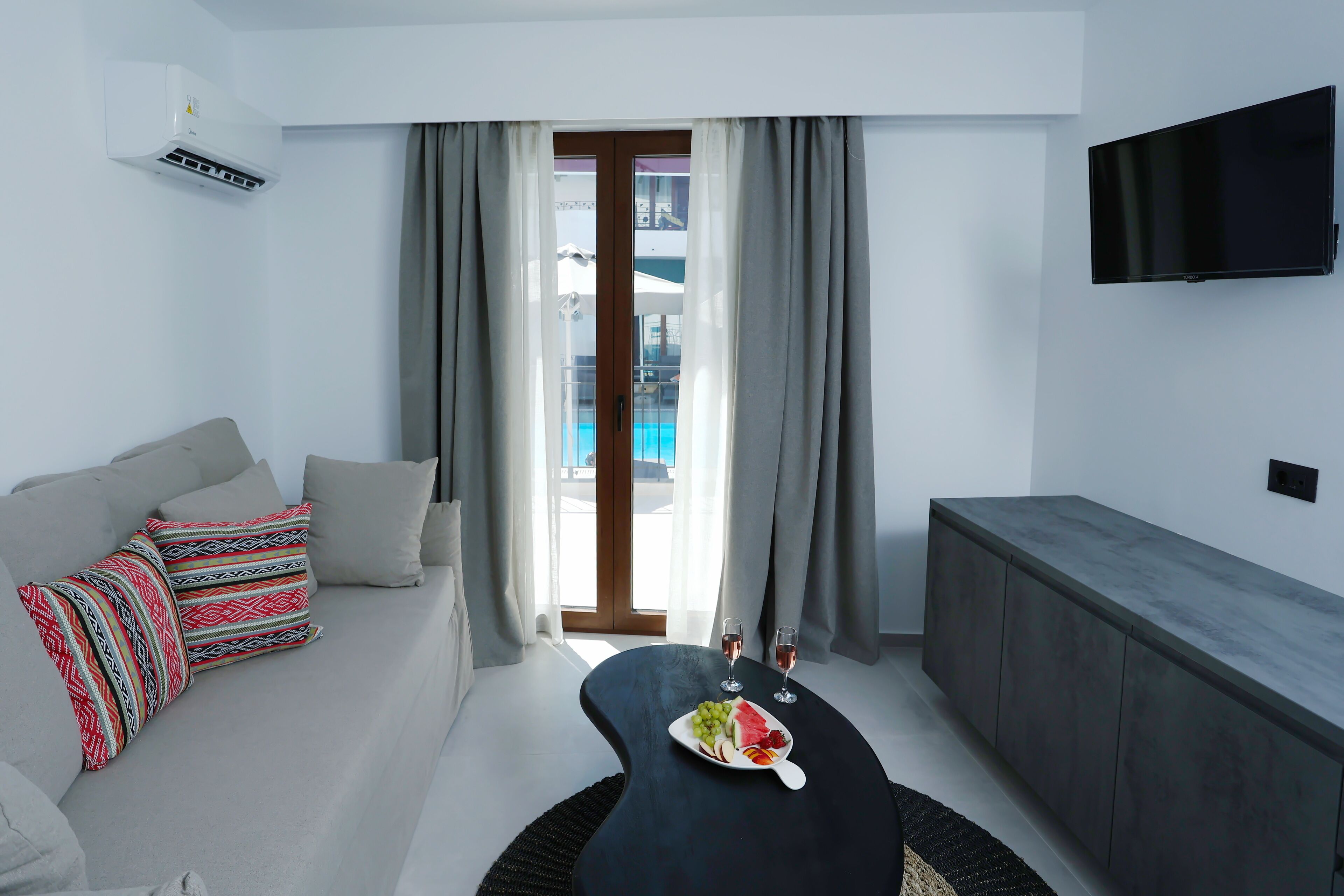 superior suite with pool view | living area | 32-inch tv with cable channels