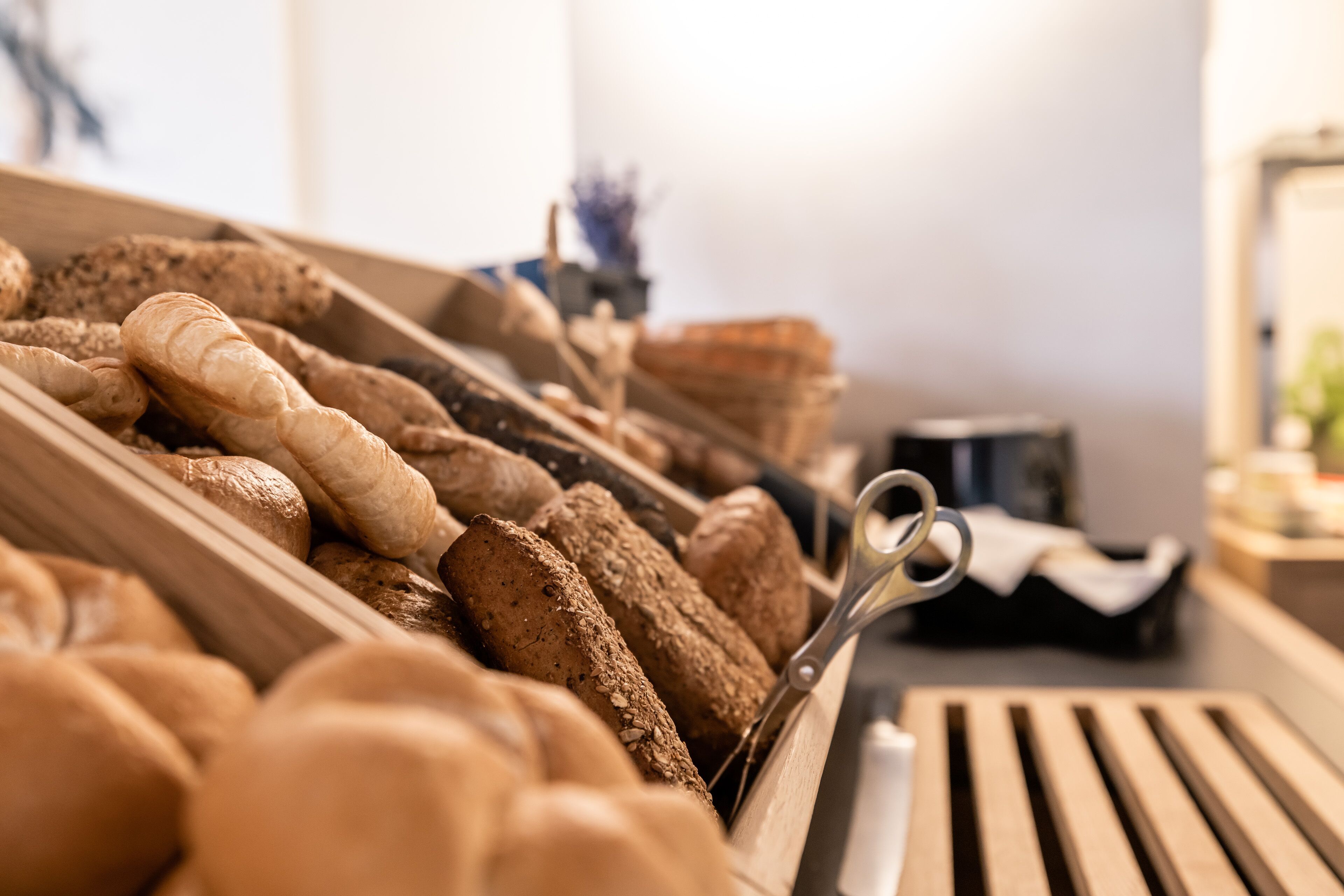 A bakery display with various types of bread and pastries.