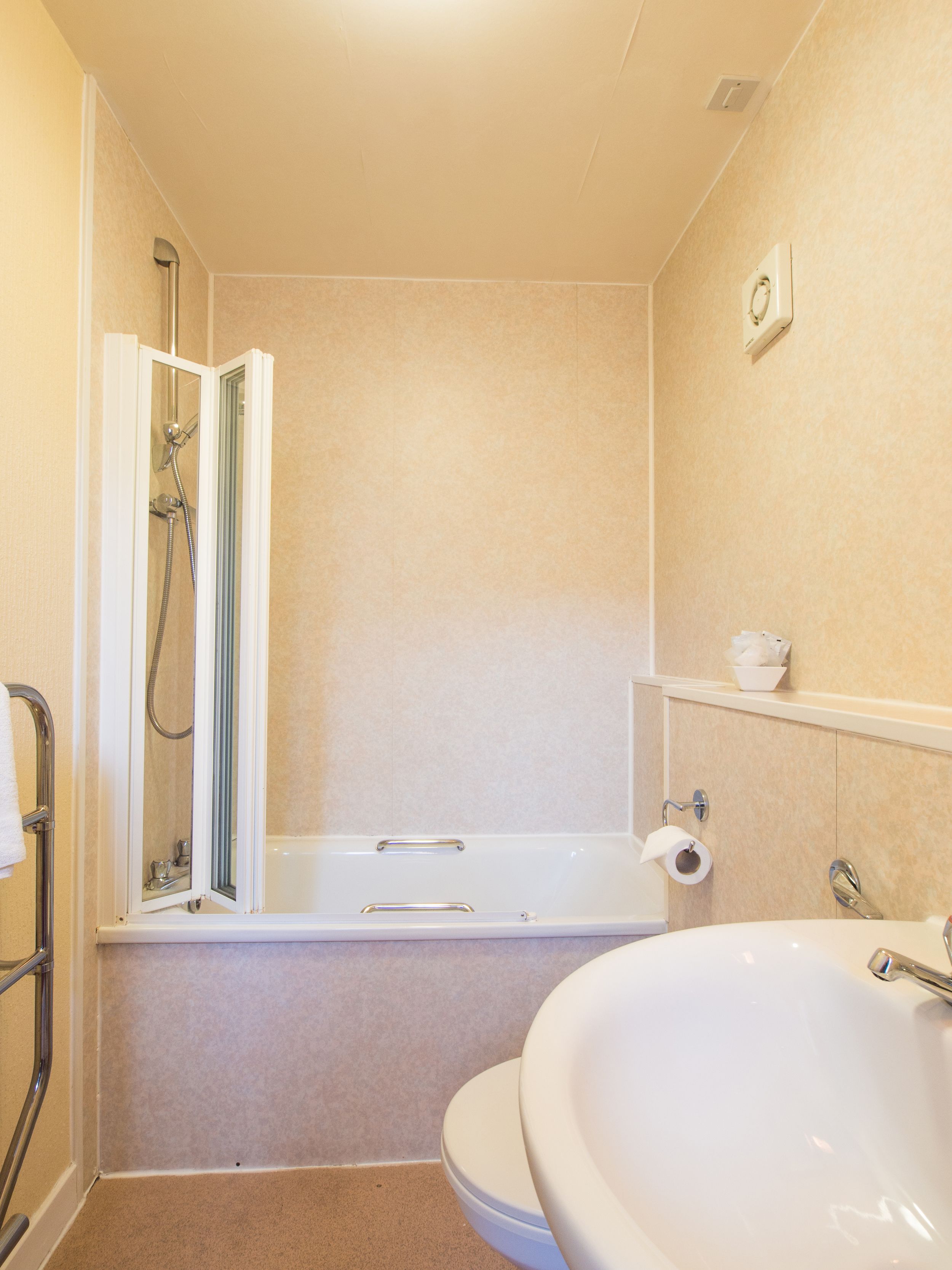 A bathroom with a shower, bathtub, and sink.