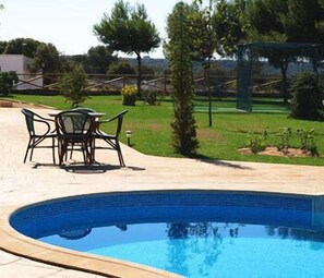 Seasonal outdoor pool, pool loungers