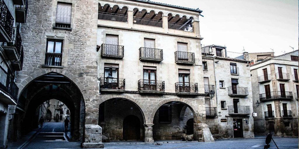 A historic building with multiple balconies and arched doorways.