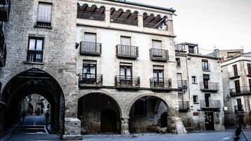 A historic building with multiple balconies and arched doorways.