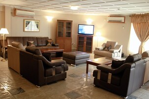Presidential Suite | Living room | 18-inch flat-screen TV with cable channels, TV