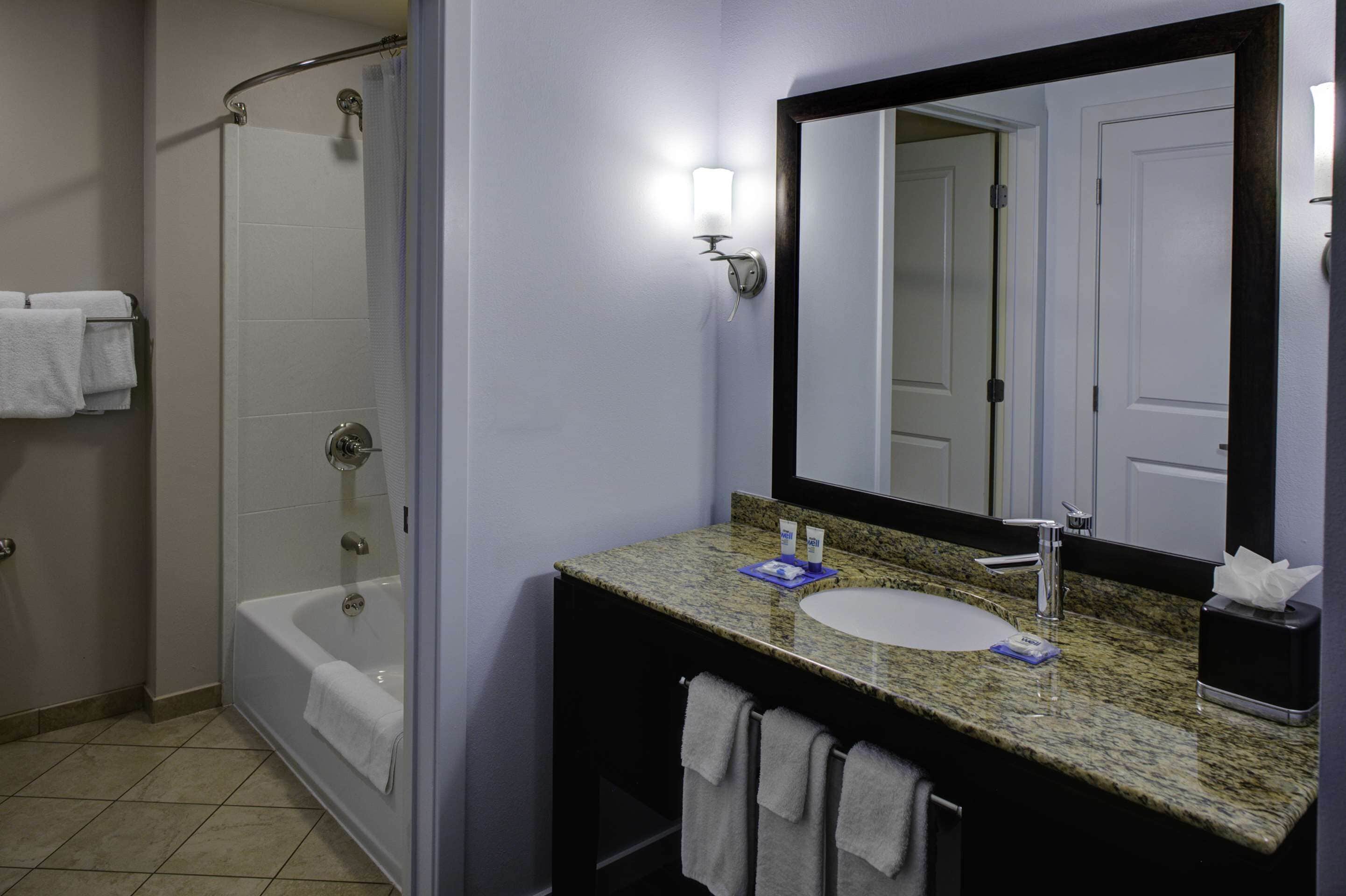 combined shower/bathtub, designer toiletries, hair dryer, towels