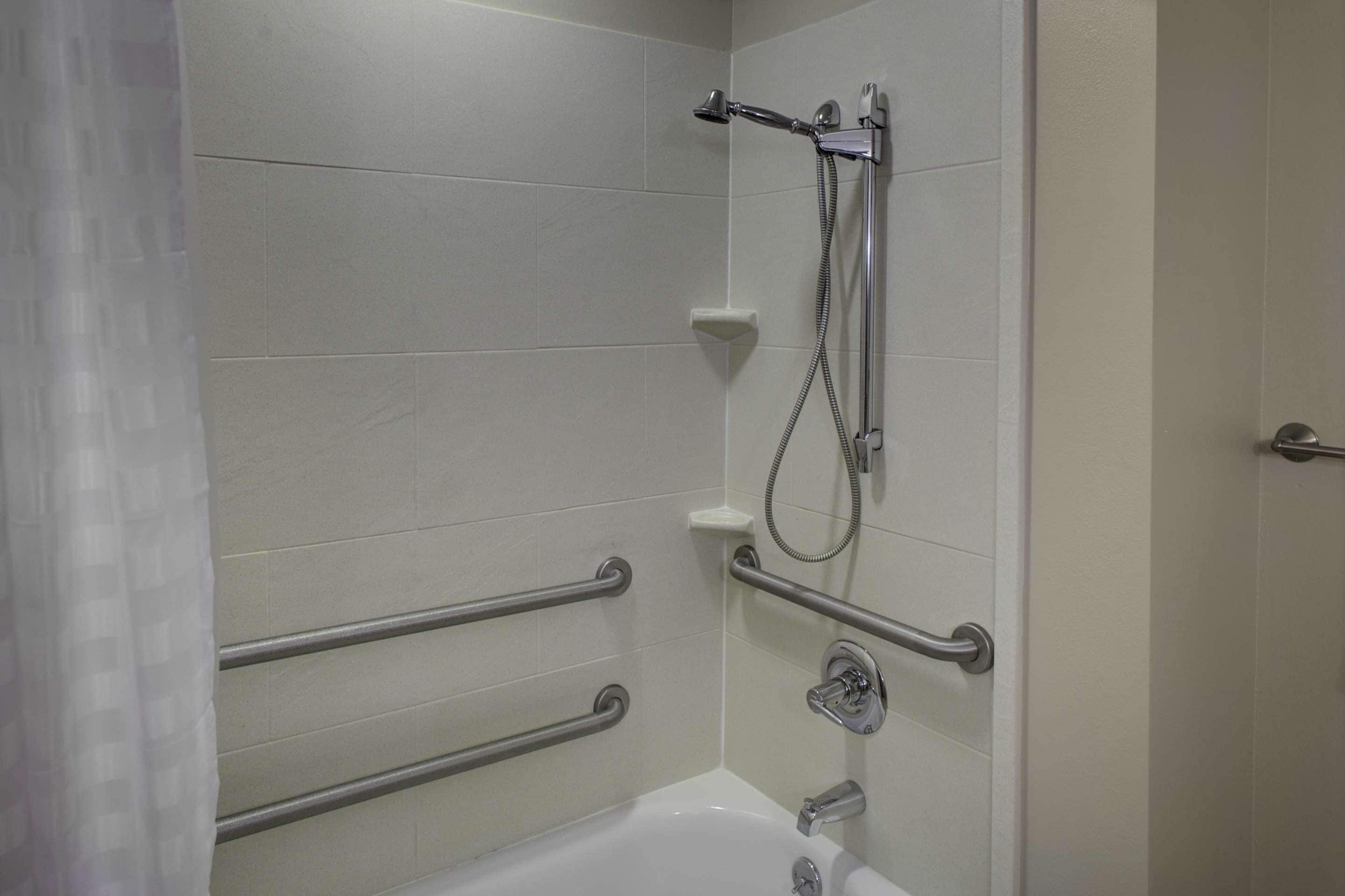 combined shower/bathtub, designer toiletries, hair dryer, towels