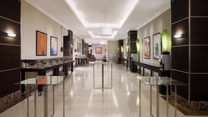 A modern hotel lobby with glass tables, artwork on the walls, and a clean, polished floor. - Four Points by Sheraton Lagos (Lagos)