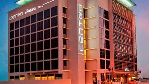 A modern building with 'CENTRO Rotana' signage, featuring a prominent glass facade and a structured, geometric design. - Centro Barsha (Dubai)