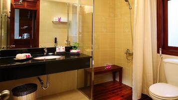 A bathroom with a shower, toilet, and sink.