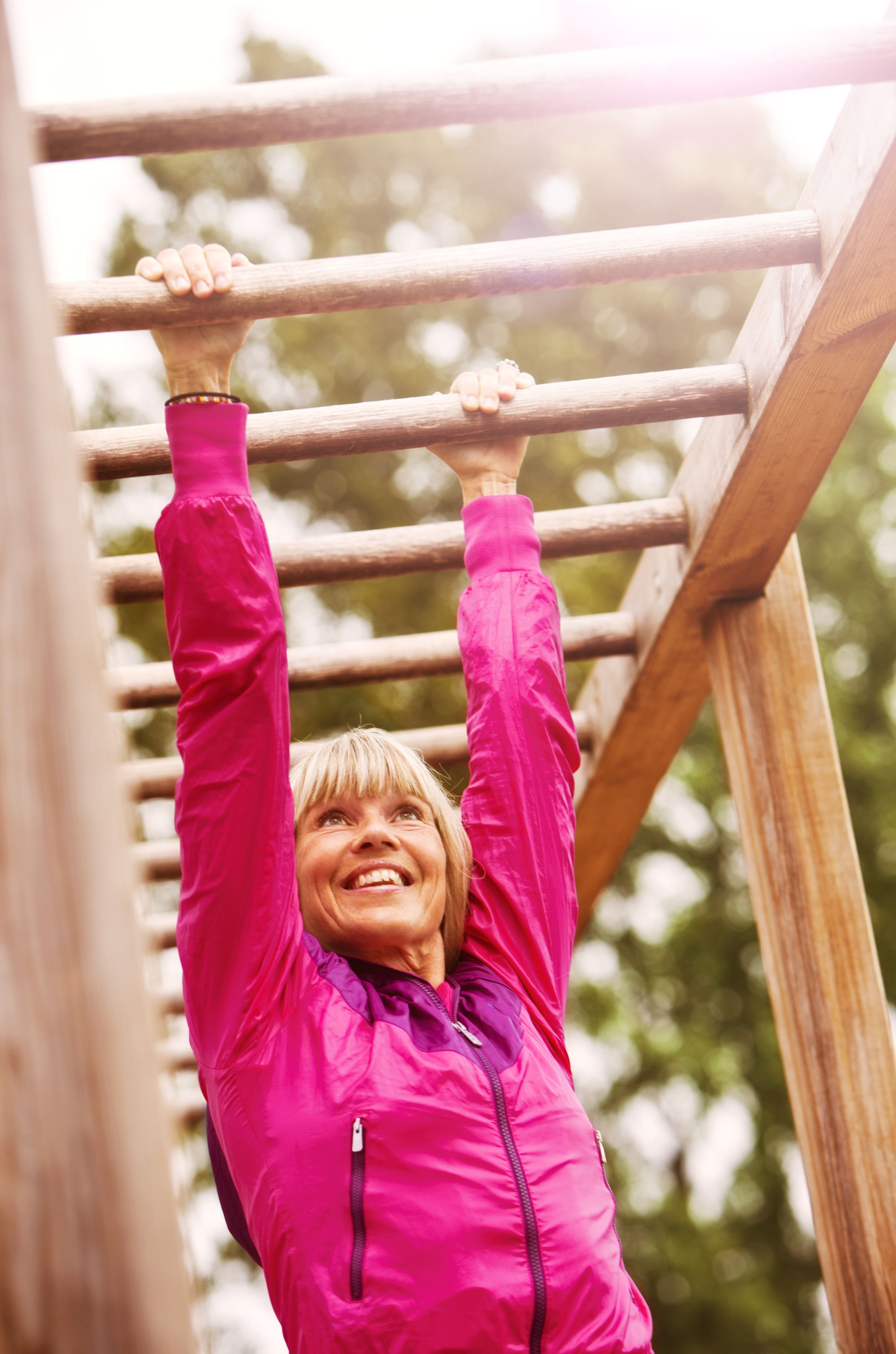 A person hanging from a wooden structure.