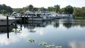 A marina with several boats docked. - Astor Bridge Marina & Motel (Astor)