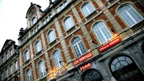 A historic building with the "La Royale Hotel" sign, featuring classic architecture with arched windows and a detailed facade. - Hotel La Royale (Leuven)