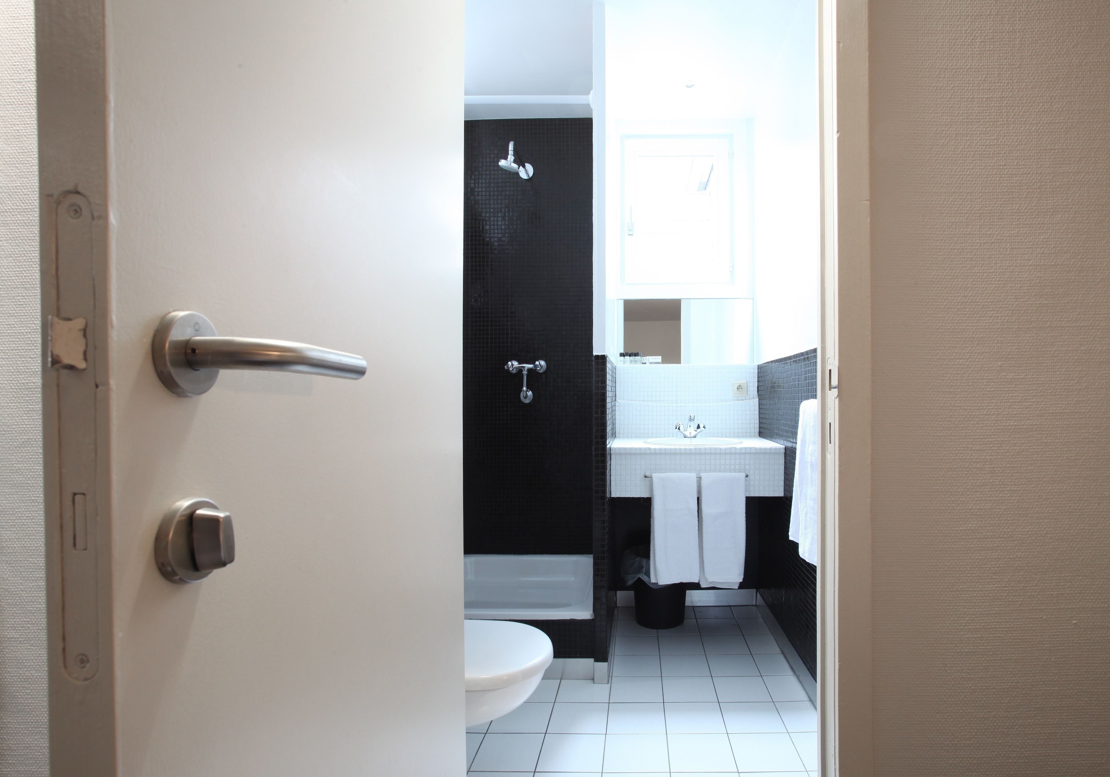 A bathroom with a toilet, sink, and shower.