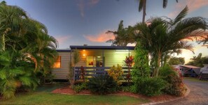 A single-story house with a porch, surrounded by tropical vegetation. - Kurrimine Beach Holiday Park (Kurrimine Beach)