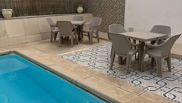 Seasonal outdoor pool, pool umbrellas, pool loungers