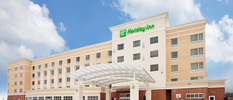 A Holiday Inn hotel with a covered entrance and multiple floors.