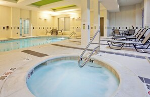 A hot tub with a 3 FT depth marker, a pool with a 5 FT depth marker, and lounge chairs around the pool area.