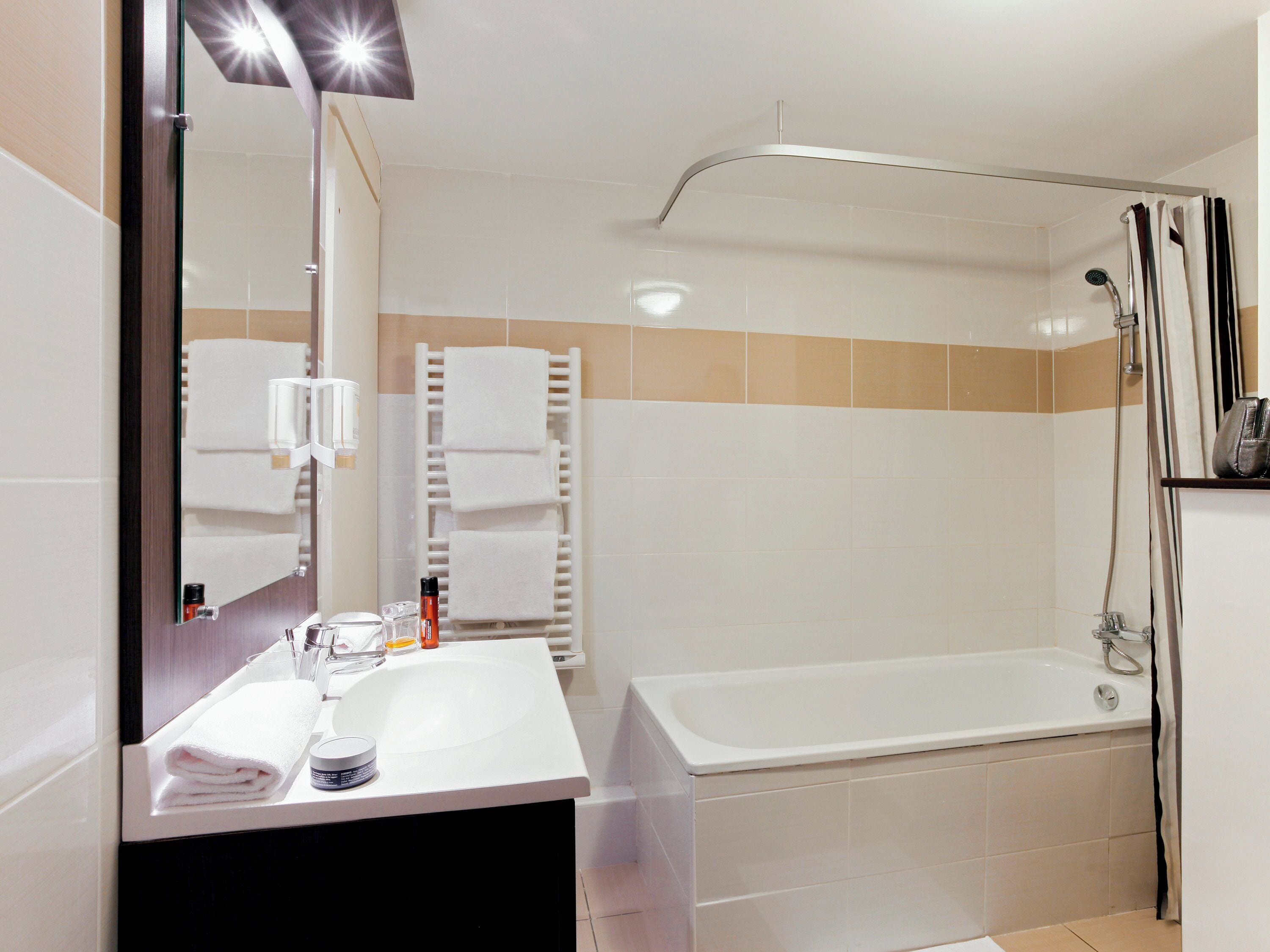 Bathtub, eco-friendly toiletries, hair dryer, towels
