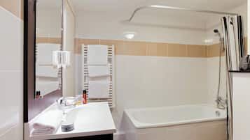 Bathtub, eco-friendly toiletries, hair dryer, towels