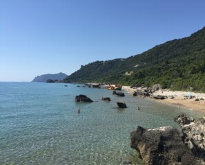 Perto da praia, espreguiçadeiras, guarda-sóis, toalhas de praia 