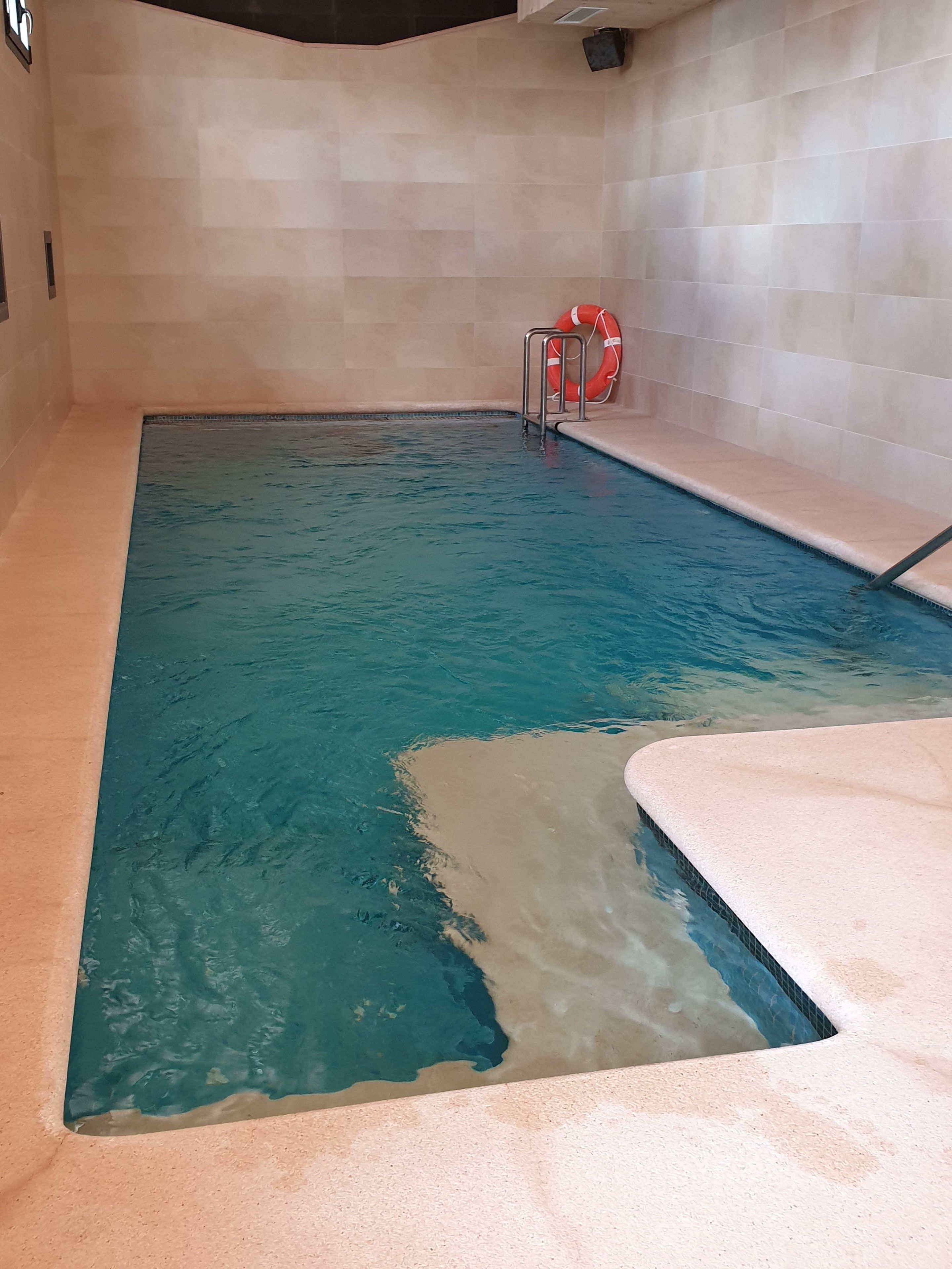 indoor pool, pool umbrellas, pool loungers