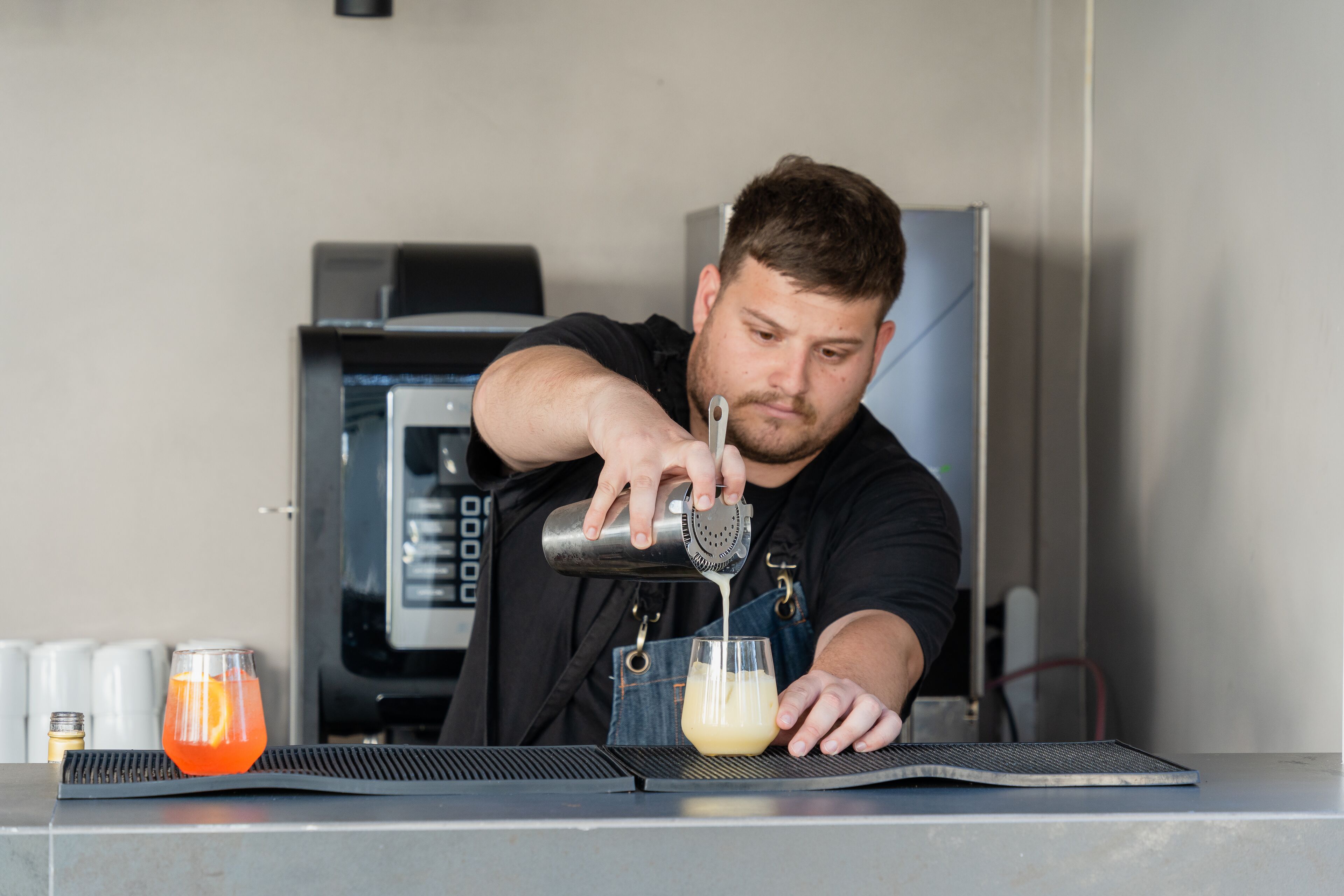 A person pouring a drink into a glass.