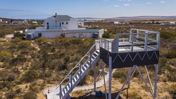 Un edificio blanco con una escalera que lleva a una plataforma panorámica.