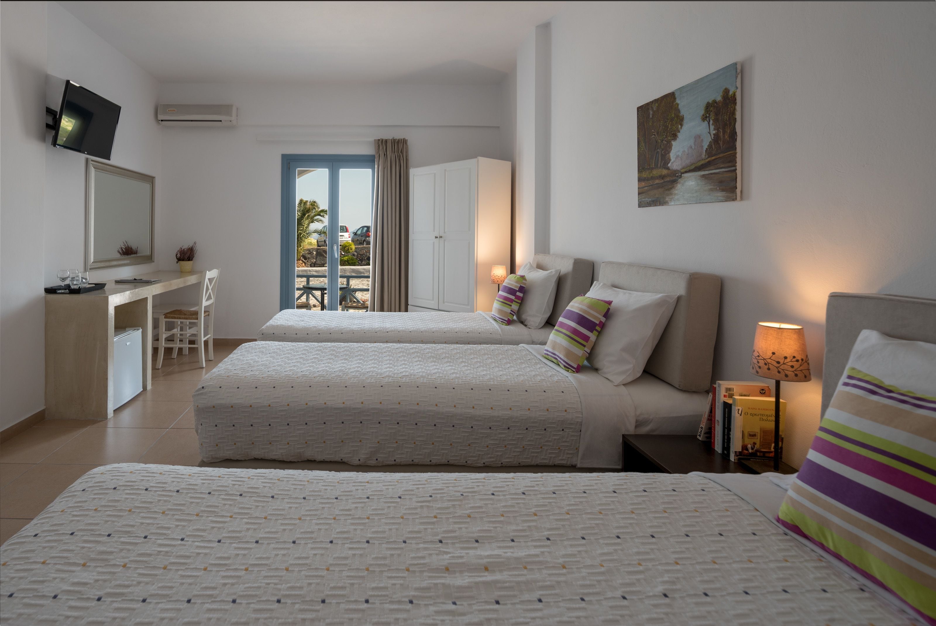 standard triple room, garden view | premium bedding, in-room safe, desk, blackout curtains