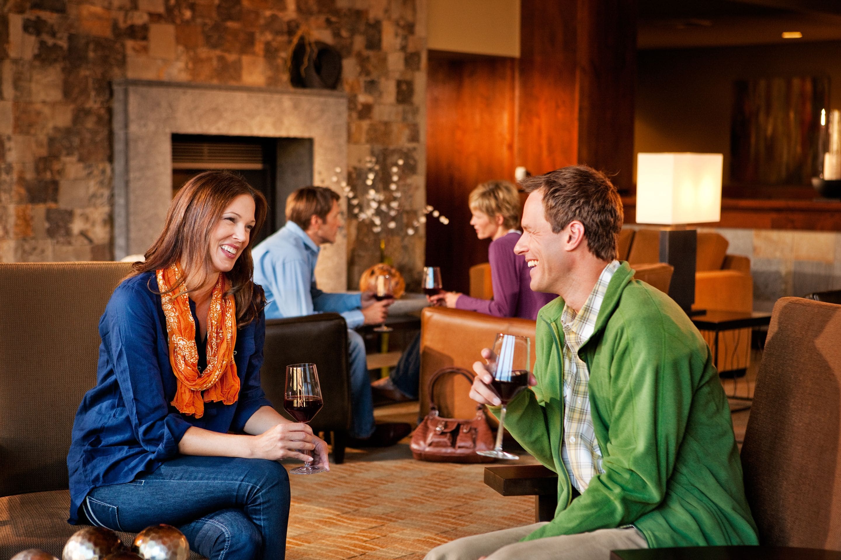 A cozy indoor setting with a fireplace, comfortable seating, and a modern decor.