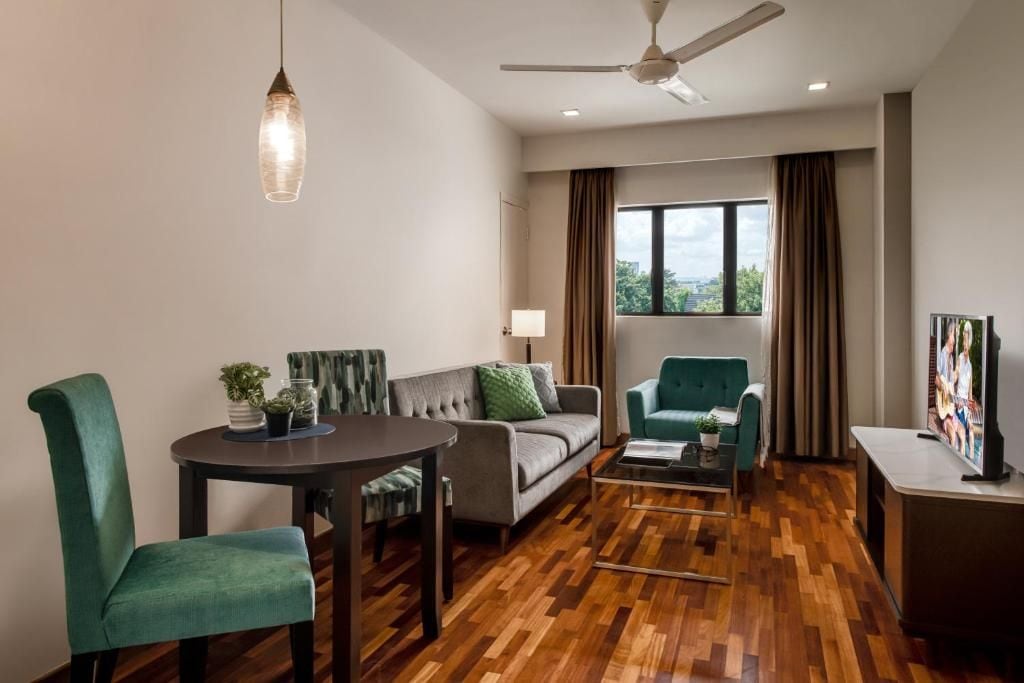 A modern living room with a sofa, chairs, a coffee table, and a television.