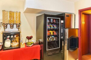 A vending machine with snacks and a milk dispenser.