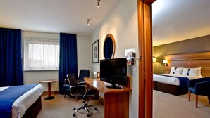 A hotel room with a bed, desk, chair, TV, and a small table. - Holiday Inn Express Shrewsbury by IHG (Shrewsbury)
