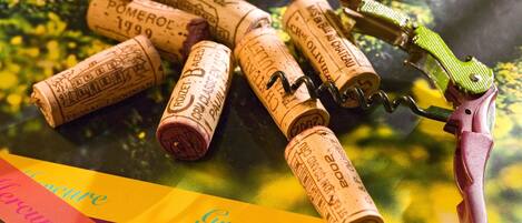 A corkscrew with corks on a colorful background.