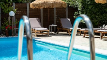 Outdoor pool, open 11:00 AM to 7:00 PM, pool umbrellas, pool loungers