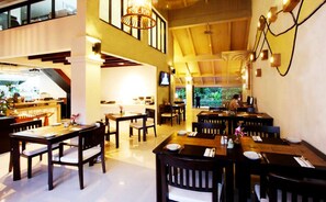 A spacious restaurant with high ceilings and multiple dining areas.