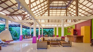 A spacious lobby with a high ceiling, large windows, and a reception desk. - Panalee Koh Samui Resort (Koh Samui)