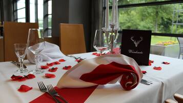 A table set with wine glasses, a folded napkin, and a menu card.