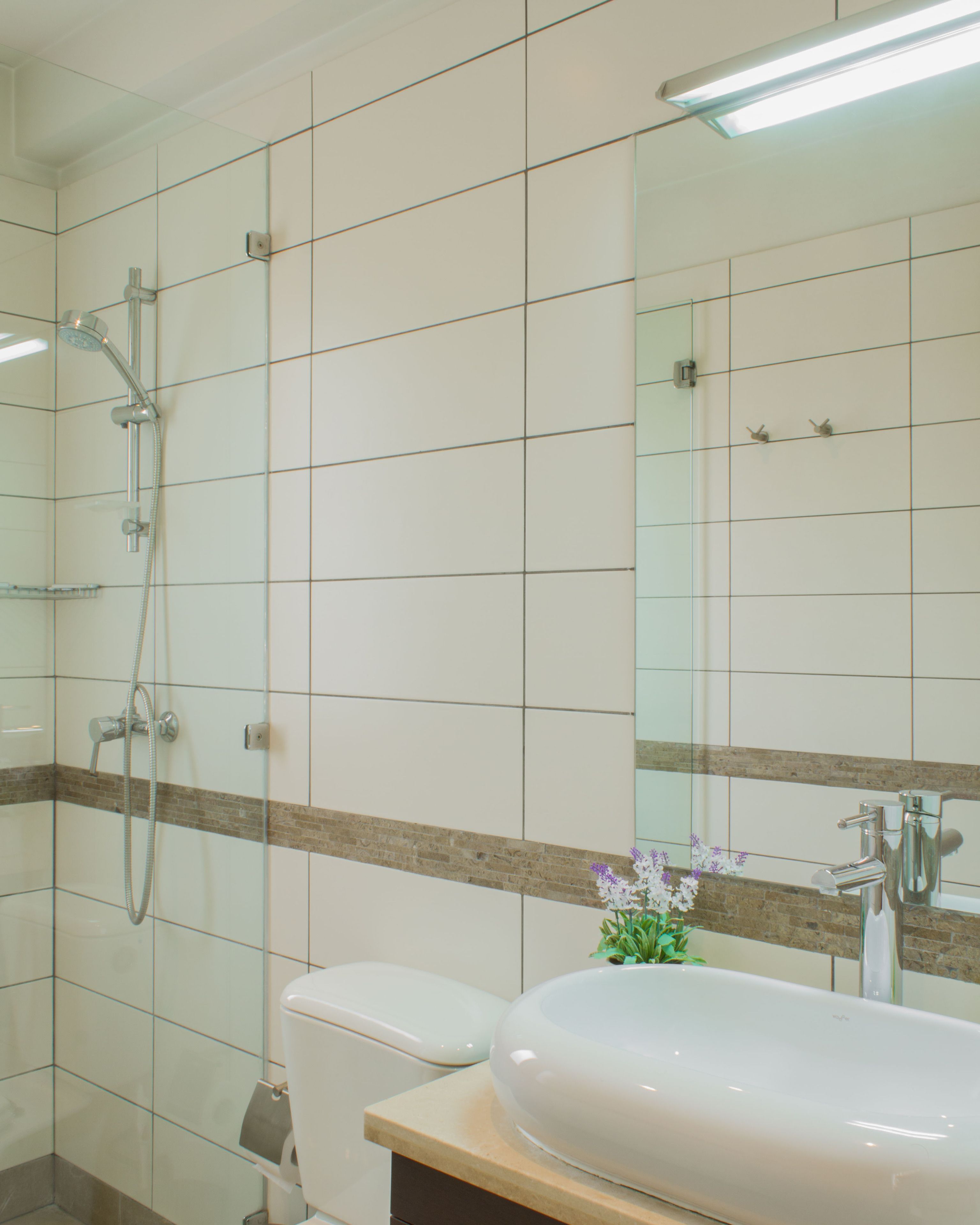 A bathroom with a toilet, a sink, and a shower.