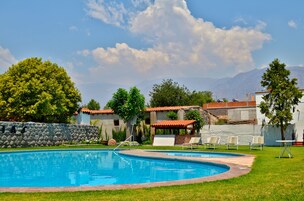 Outdoor pool, open 9 AM to 8 PM, pool umbrellas, sun loungers