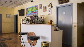 A bar area with stools, a coffee machine, and a 'No Smoking Area' sign.