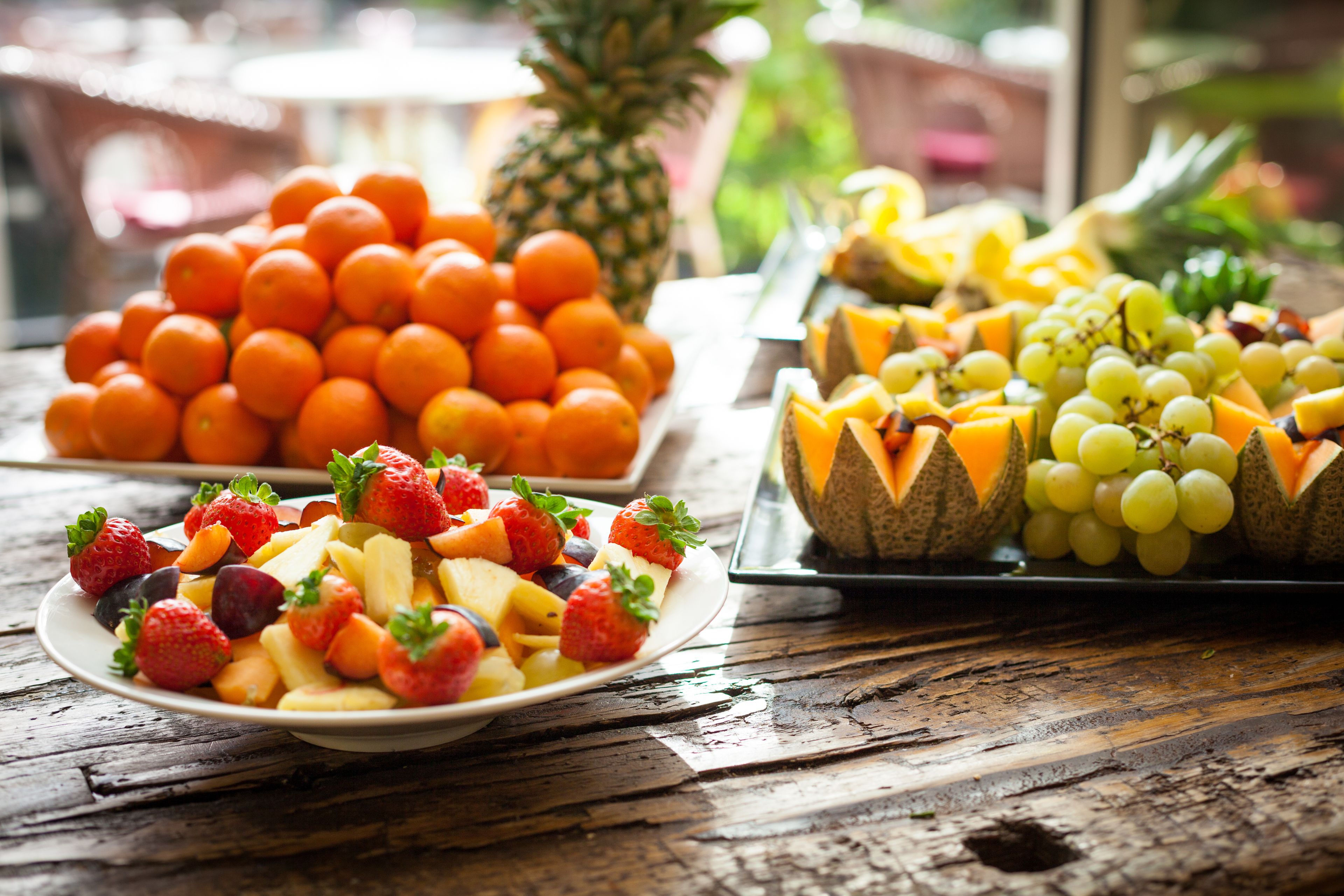 A variety of fruits arranged on a wooden table.