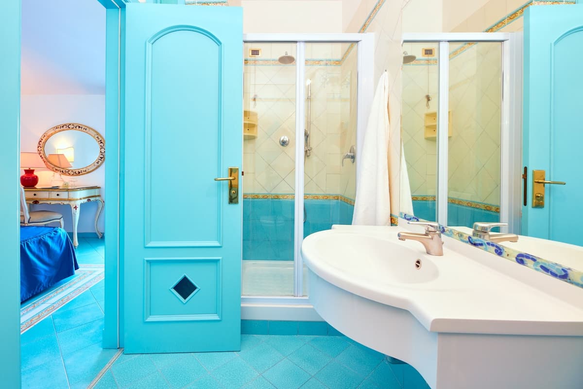 designer toiletries, hair dryer, bathrobes, slippers