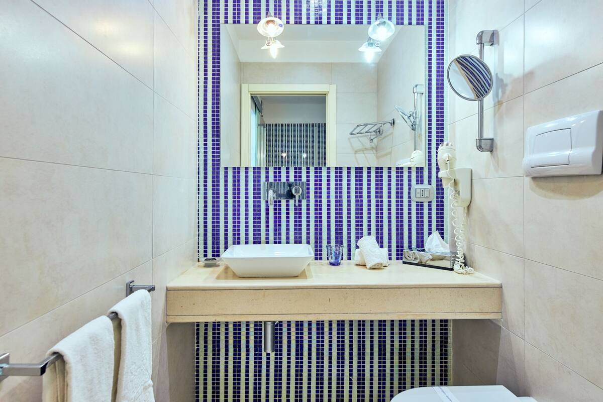 deluxe room, 1 bedroom, sea view | bathroom | designer toiletries, hair dryer, bathrobes, slippers