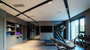 A modern gym with treadmills, a bench, and weight racks. - Mercure Harbin Central Street Sophia Church (Harbin)