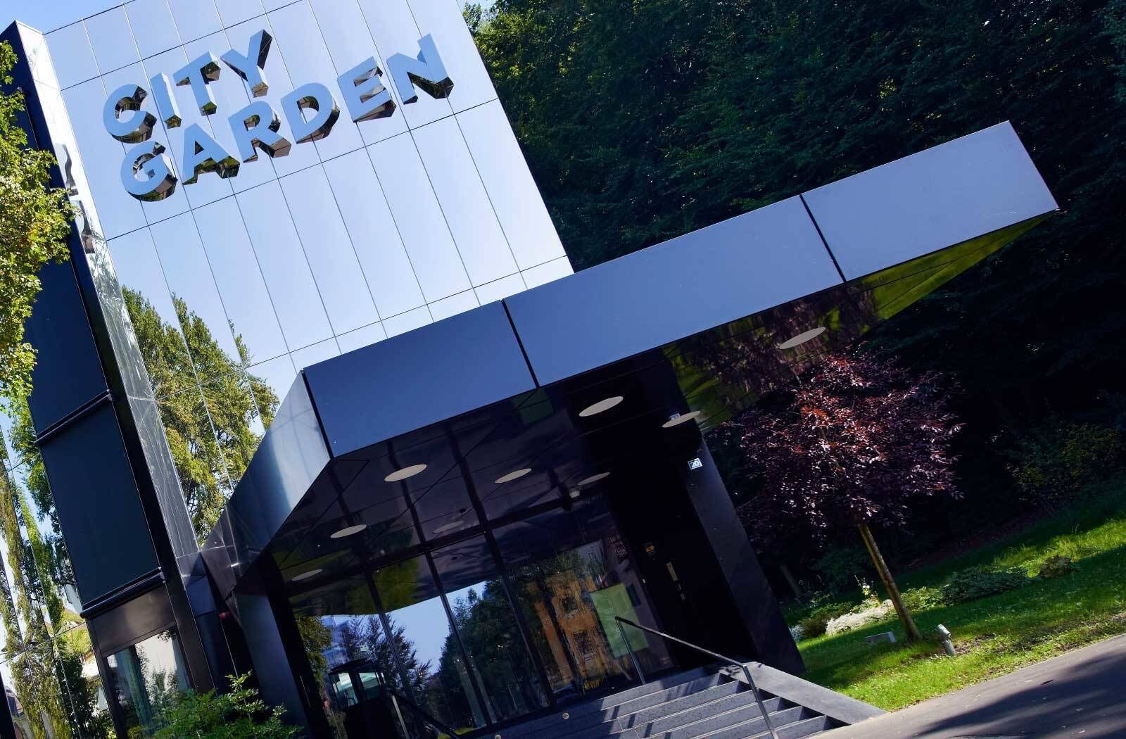 A modern building with a sign reading "CITY GARDEN".