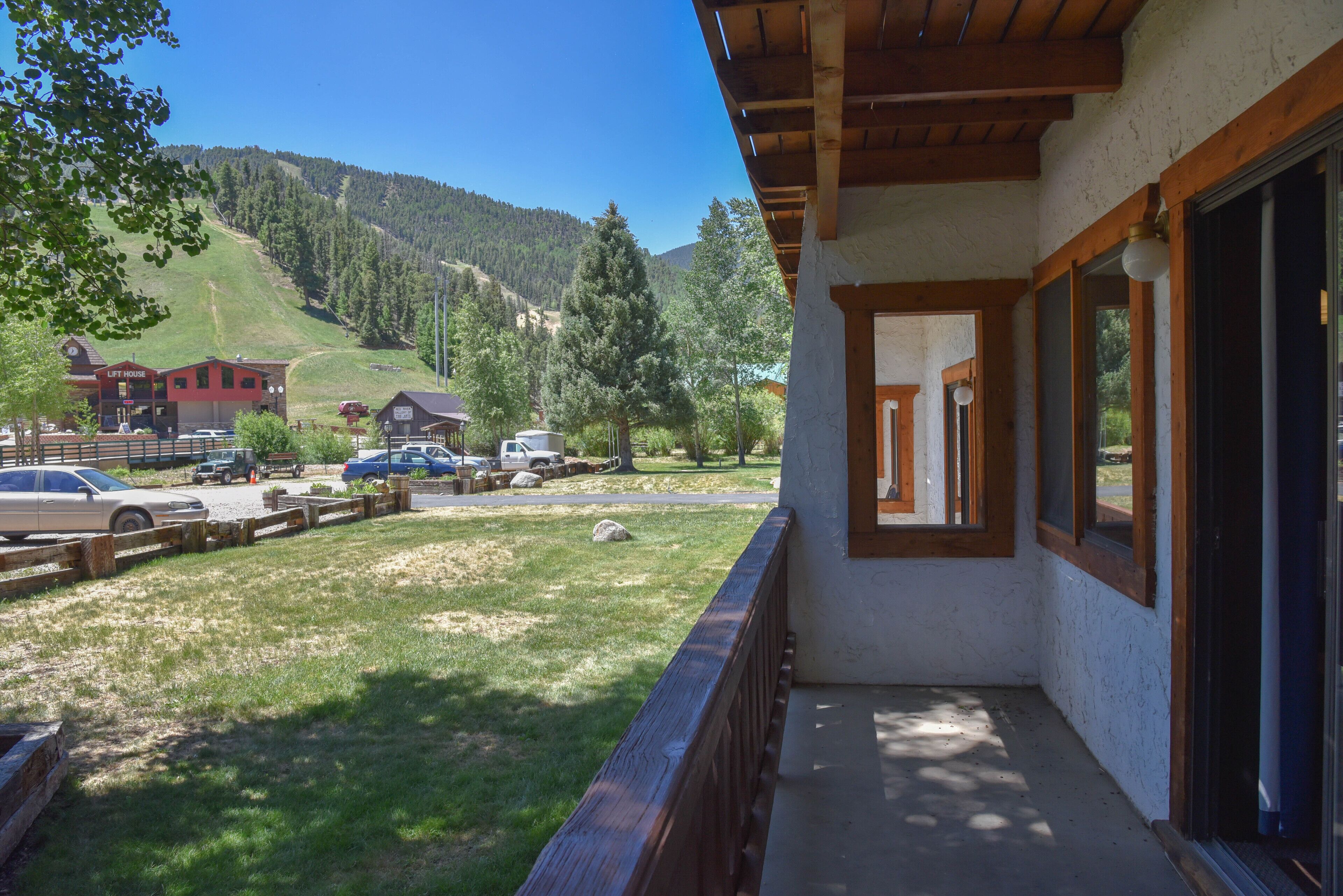 A balcony with a view of a ski lift and a mountain.