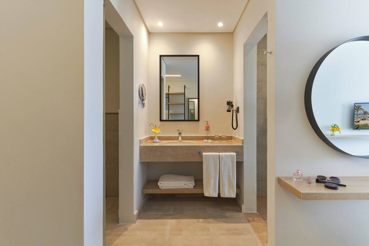 premium triple room | bathroom | shower, hair dryer, towels